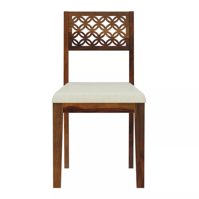 Wooden chair with decorative backrest and white cushion on a white background