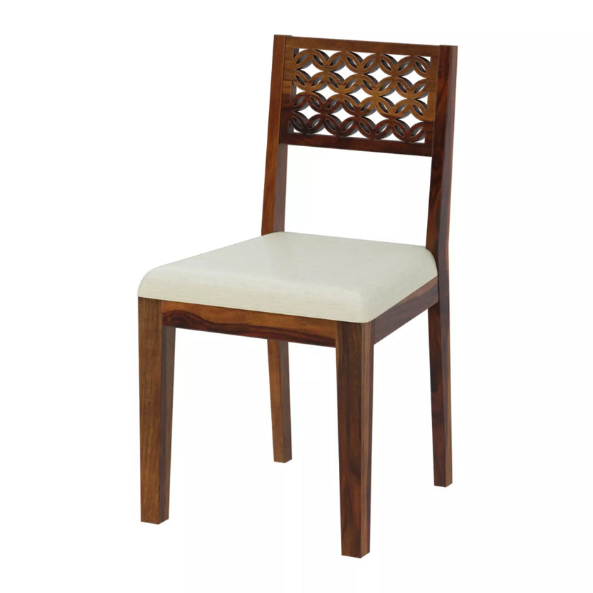Wooden chair with a decorative backrest and white cushion on a white background
