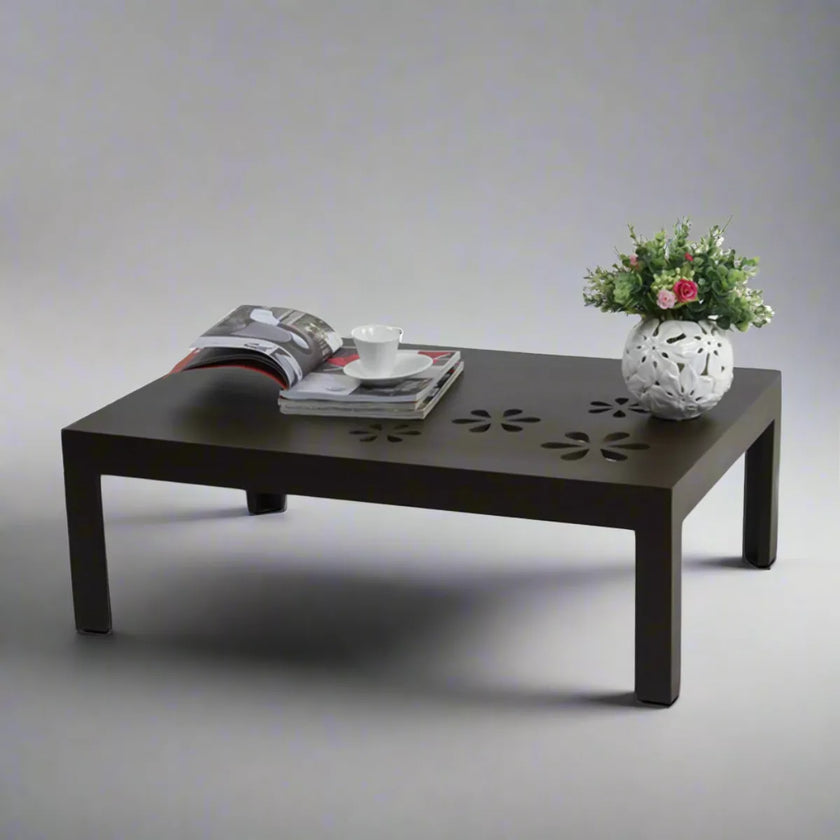 Black coffee table with decorative elements on a gray background