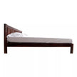 Wooden bed frame with white mattress on a white background