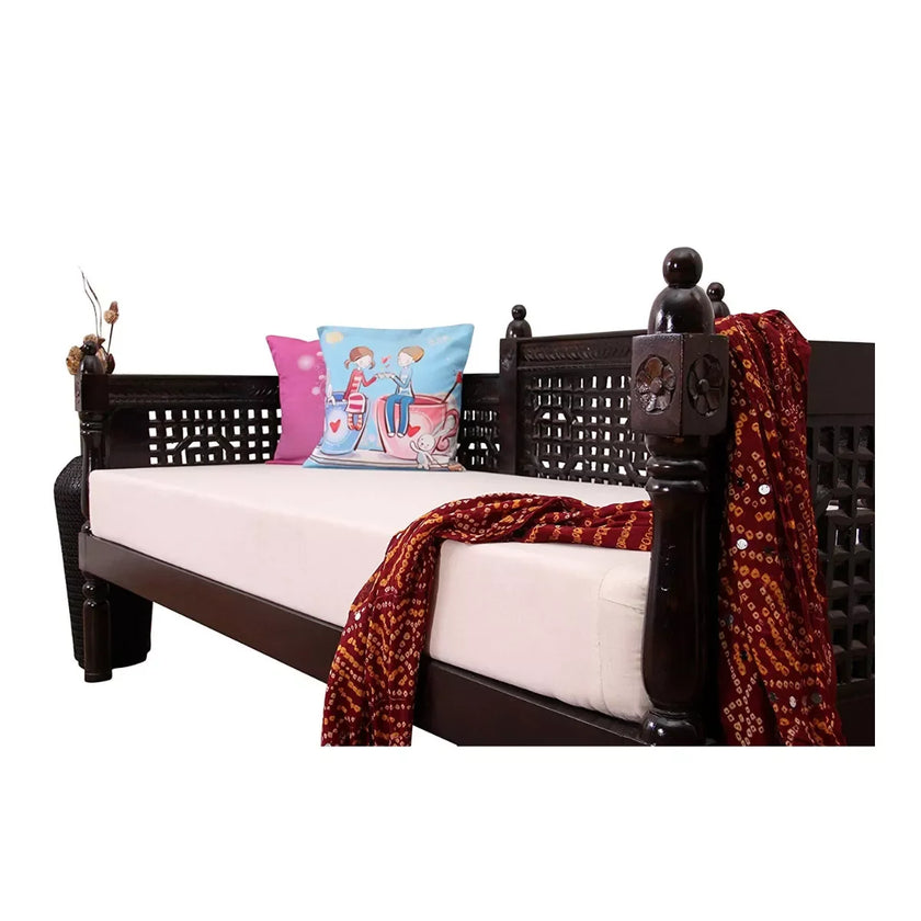 Wooden daybed with cushions and a blanket on a white background