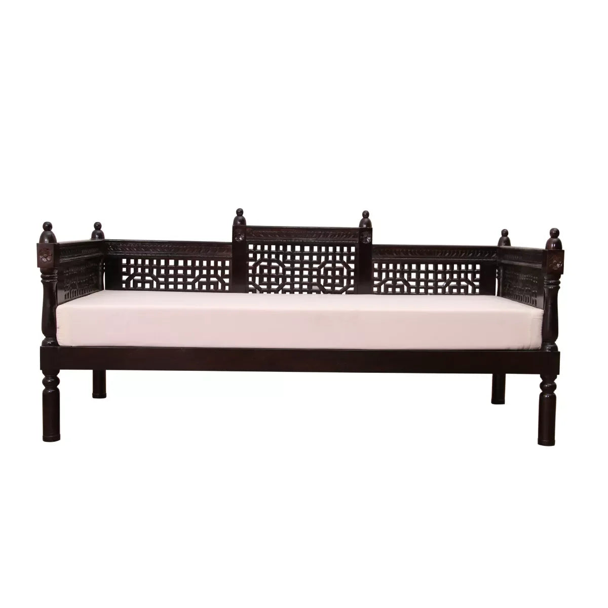 Wooden daybed with intricate carvings and a white cushion on a white background