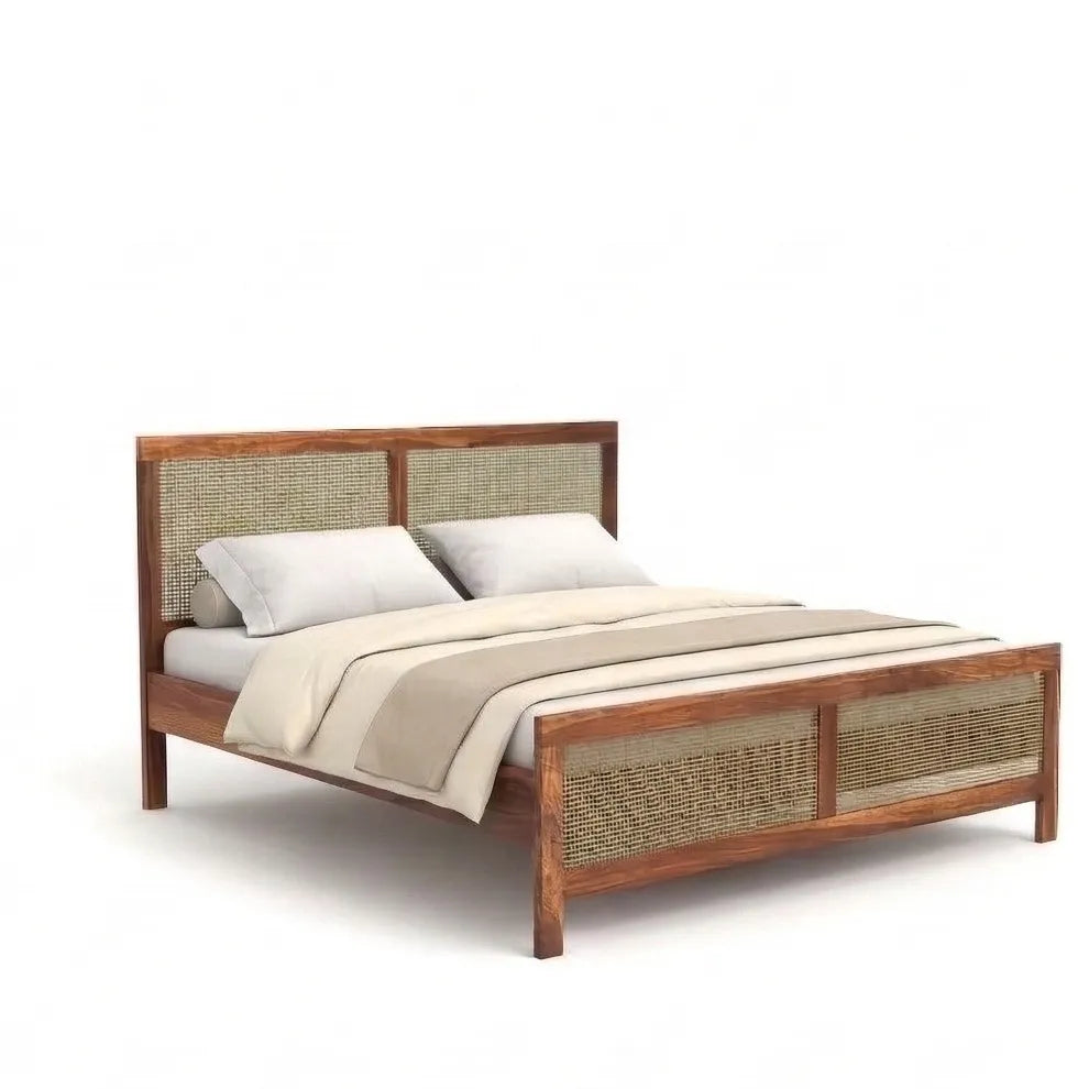 Wooden bed with wicker headboard and footboard on a white background