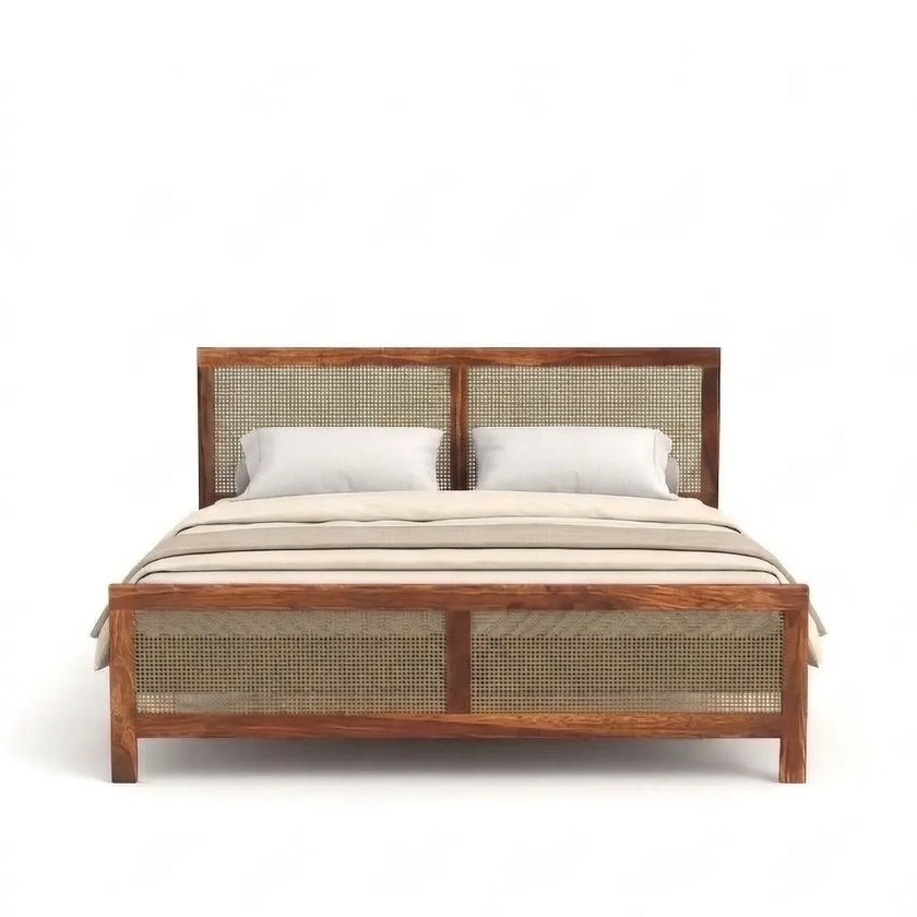 Wooden bed with wicker headboard and footboard on a white background