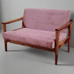 Pink sofa with wooden frame on a gray background