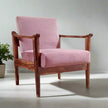 Pink sofa armchair with wooden frame on a light gray background