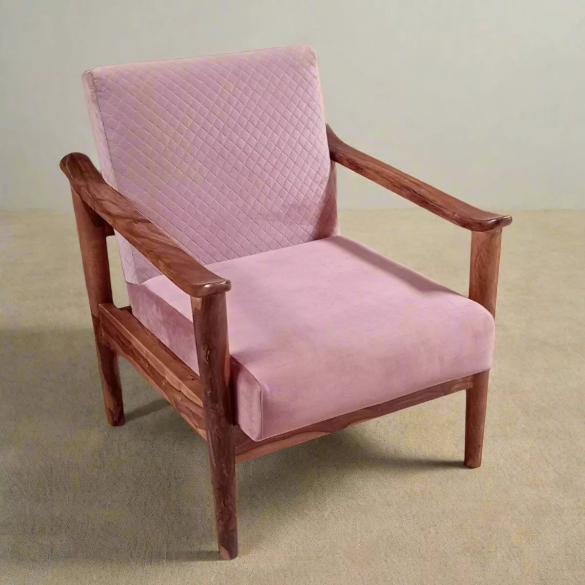 Pink sofa chair with wooden frame on a beige floor and light gray wall background