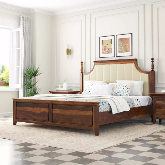 Wooden bed in a bedroom with white walls and decorative elements.