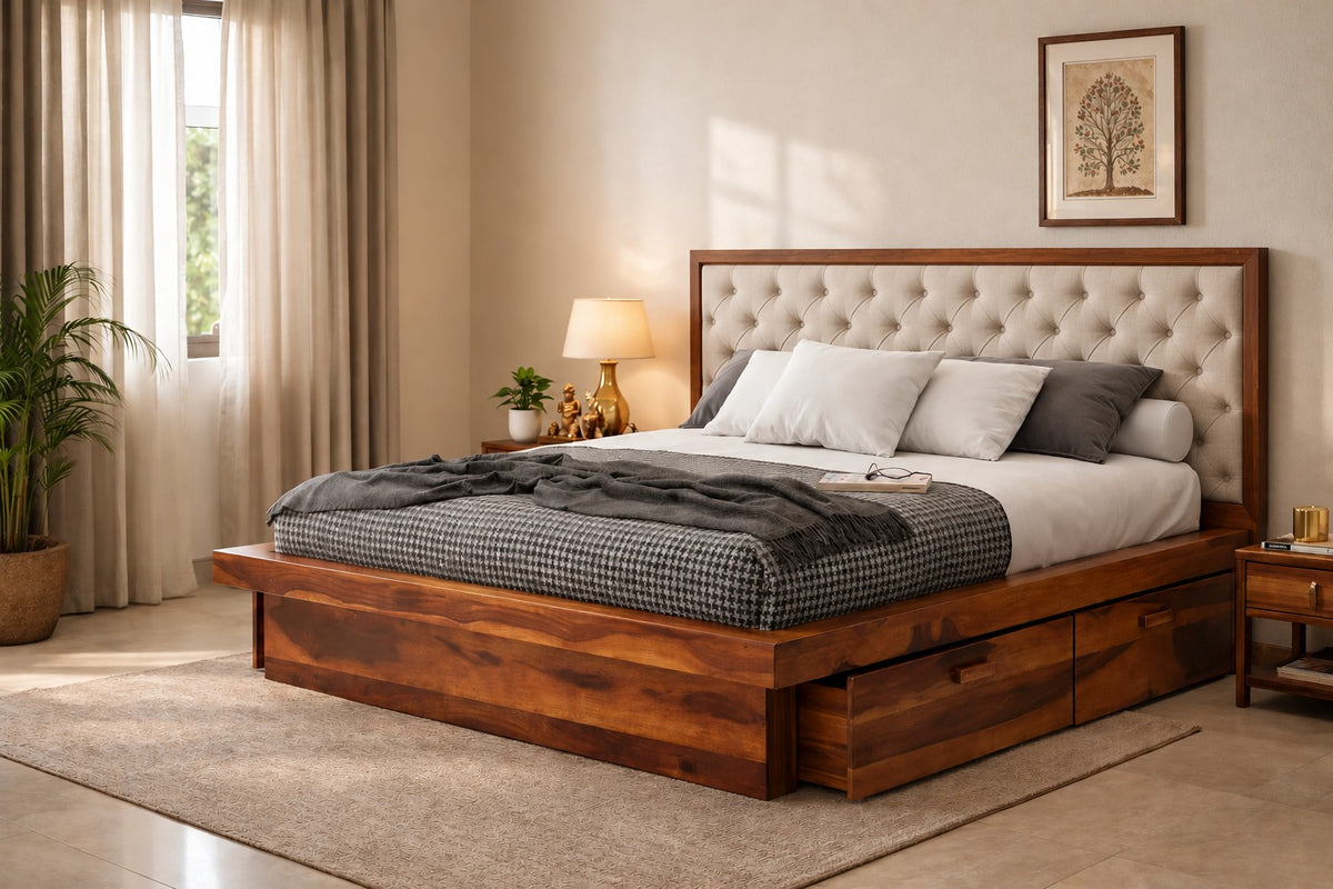 A wooden platform bed with a tufted beige headboard, styled in a warm, modern bedroom with neutral bedding, a side table, and a plant.