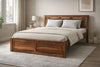 Wooden bed with slatted headboard in a bedroom setting with neutral decor