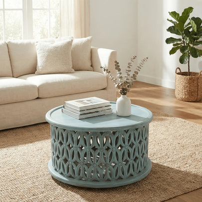 Aarav carved round coffee table in blue distressed finish in a living room