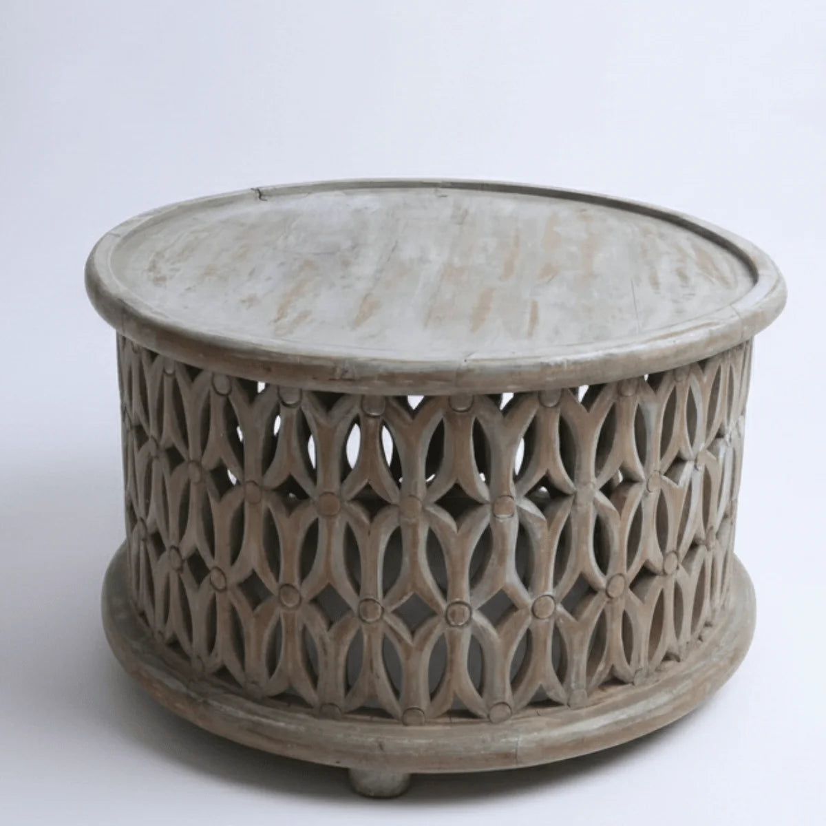 Aarav hand carved round wooden coffee table with white distressed jali pattern