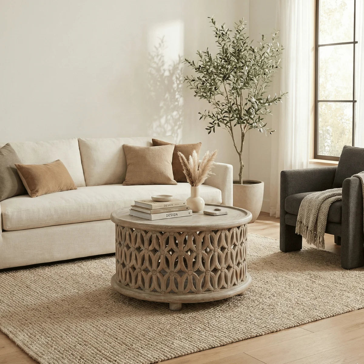 Aarav carved round coffee table in white distressed finish in a living room