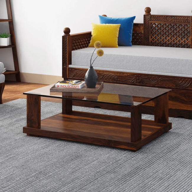 Aeron modern rectangular sheesham wood coffee table with glass top in a living room