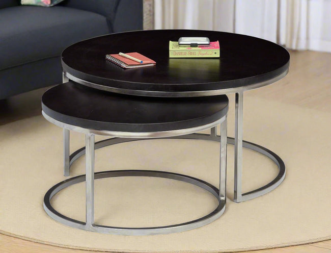 Axton round nesting coffee tables set of 2 with wood top and silver iron base in a living room