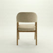 Back view of Brendon solid wood dining chair with curved upholstered backrest and cushioned seat.