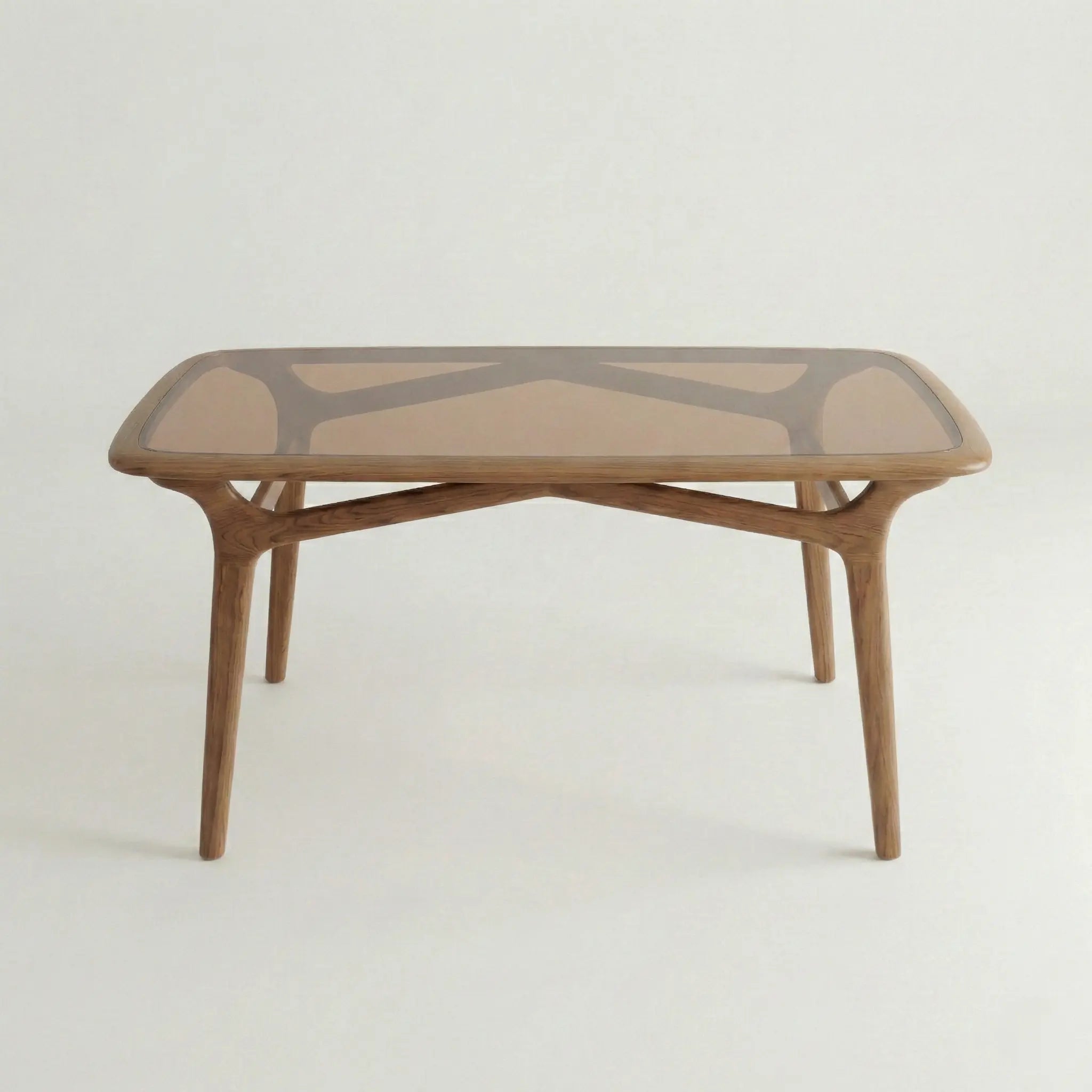 Front view of Brendon wood and glass dining table with sculpted wooden base.