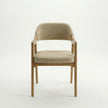 Front view of Brendon upholstered dining chair featuring solid wood legs and padded fabric seating.