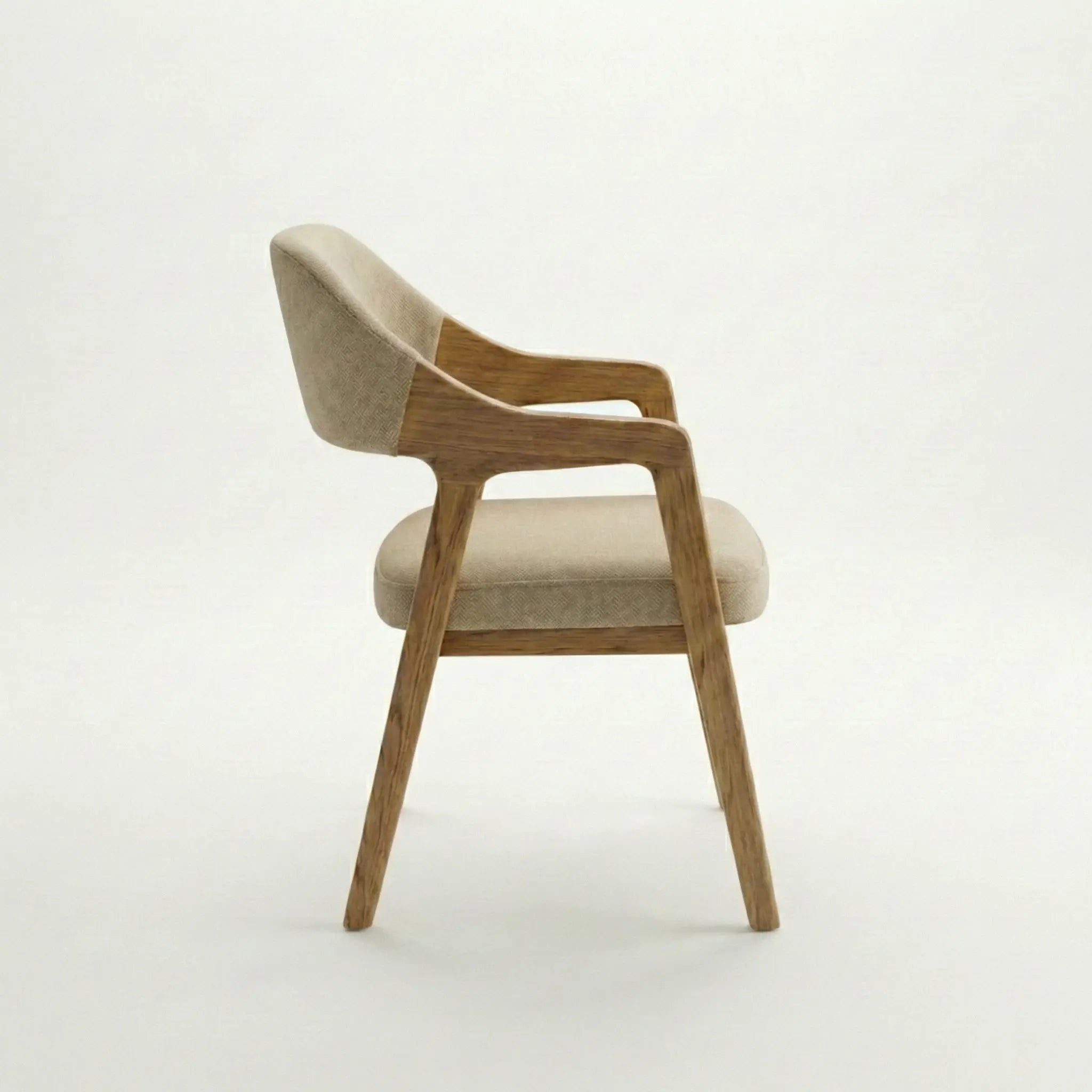 Side view of Brendon upholstered dining chair with solid wood frame and cushioned beige fabric seat.