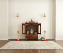 Divine sheesham wood pooja mandir for homewith glass doors and drawer placed against the wall premium interior zoom-out view