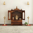 Divine sheesham wood pooja mandir for homewith glass doors and drawer placed against the wall premium interior