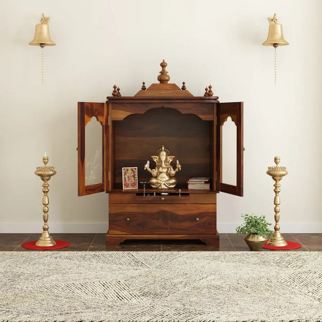 Divine sheesham wood pooja mandir for homewith glass doors and drawer placed against the wall premium interior