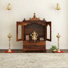 Divine sheesham wood pooja mandir for homewith glass doors and drawer placed against the wall premium interior