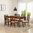 A wooden dining set comprising a rectangular table and six chairs with beige cushions, placed in a room with a window, a pendant light, and a floral arrangement on the table.