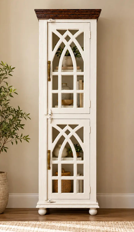 Haveli wooden display cabinet with arched glass doors placed against the wall in a living room