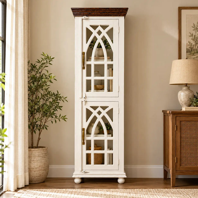 Haveli wooden display cabinet with arched glass doors placed against the wall in a living room