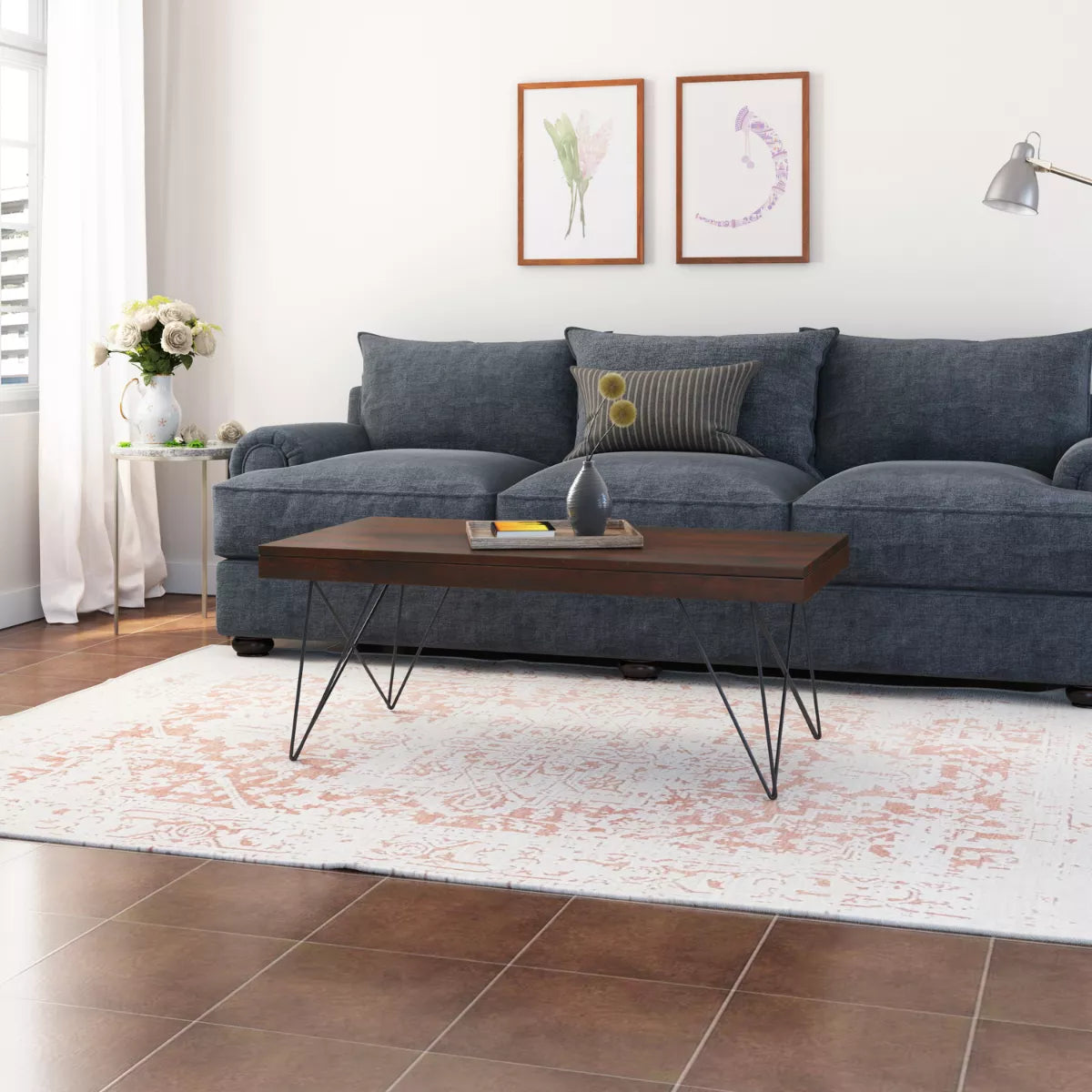 Kiana sheesham coffee table with hairpin metal legs in front of a blue sofa