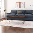 Kiana sheesham coffee table with hairpin metal legs in front of a blue sofa
