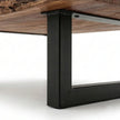 Black powder-coated metal leg detail of live edge solid wood coffee table