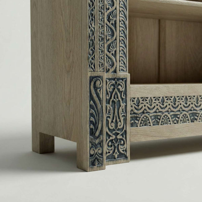 Closeup view of Meher rustic teak wood hand-carved display cabinet emphasizing light wood shelves and carved pedestal base