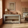 Meher rustic teak wood hand-carved open display cabinet in terracotta bedroom interior with jali screens, books, and elephant decor.