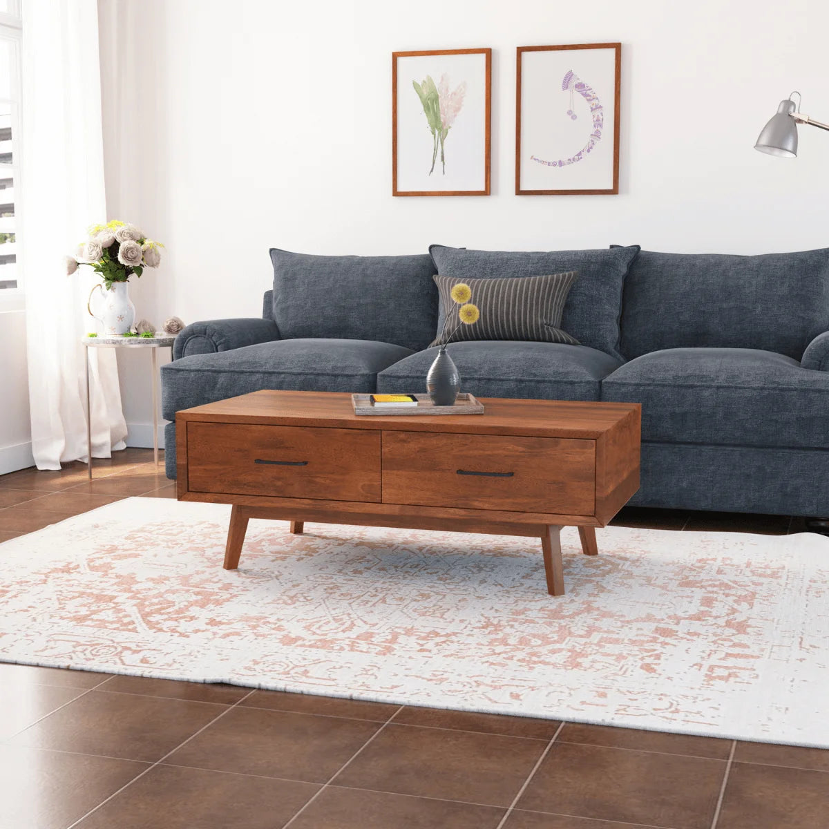 Nidaan sheesham coffee table with 2 drawers in front of a blue sofa