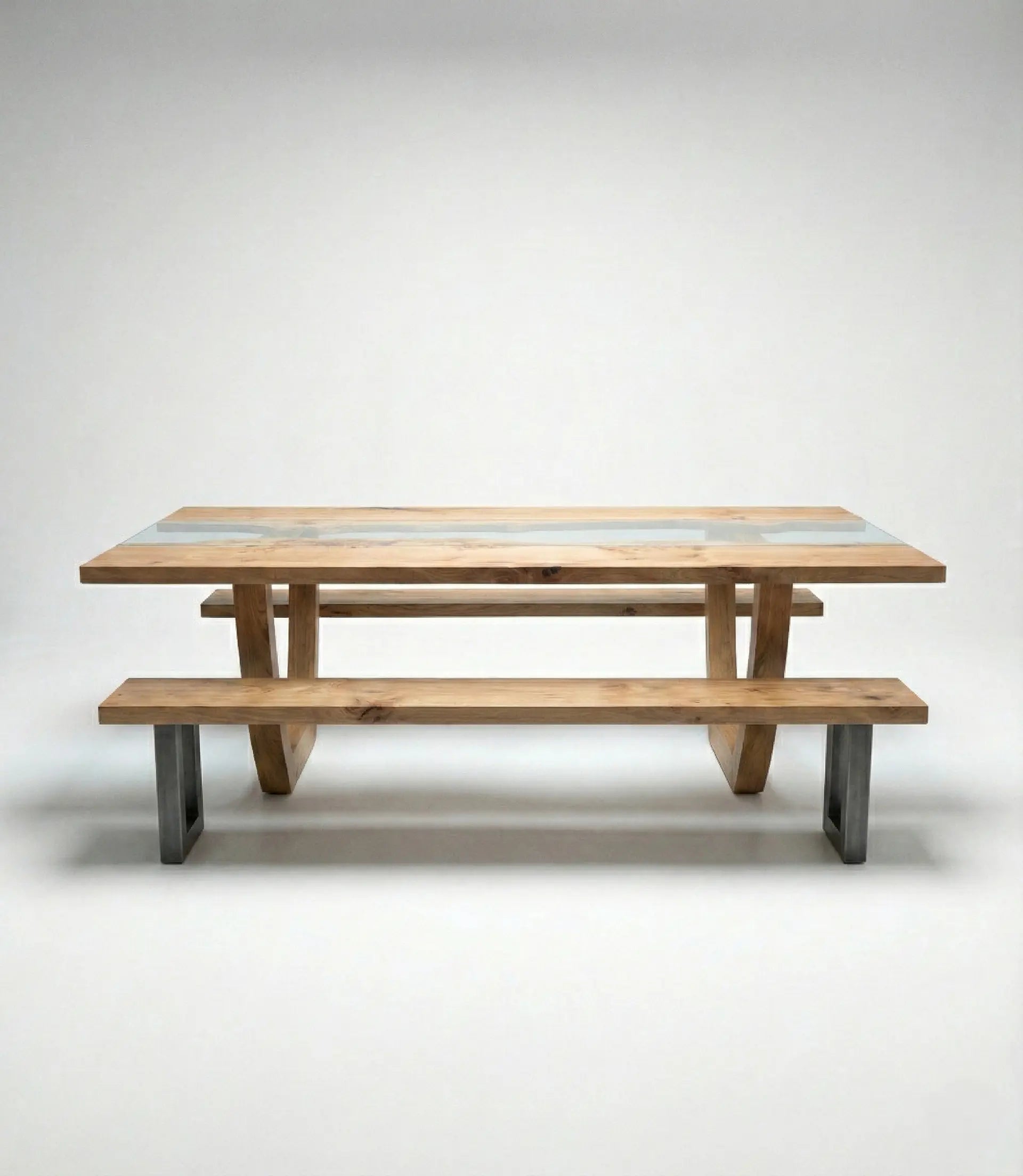 Front view of Nolan solid wood glass top dining table with matching wooden benches and metal legs.