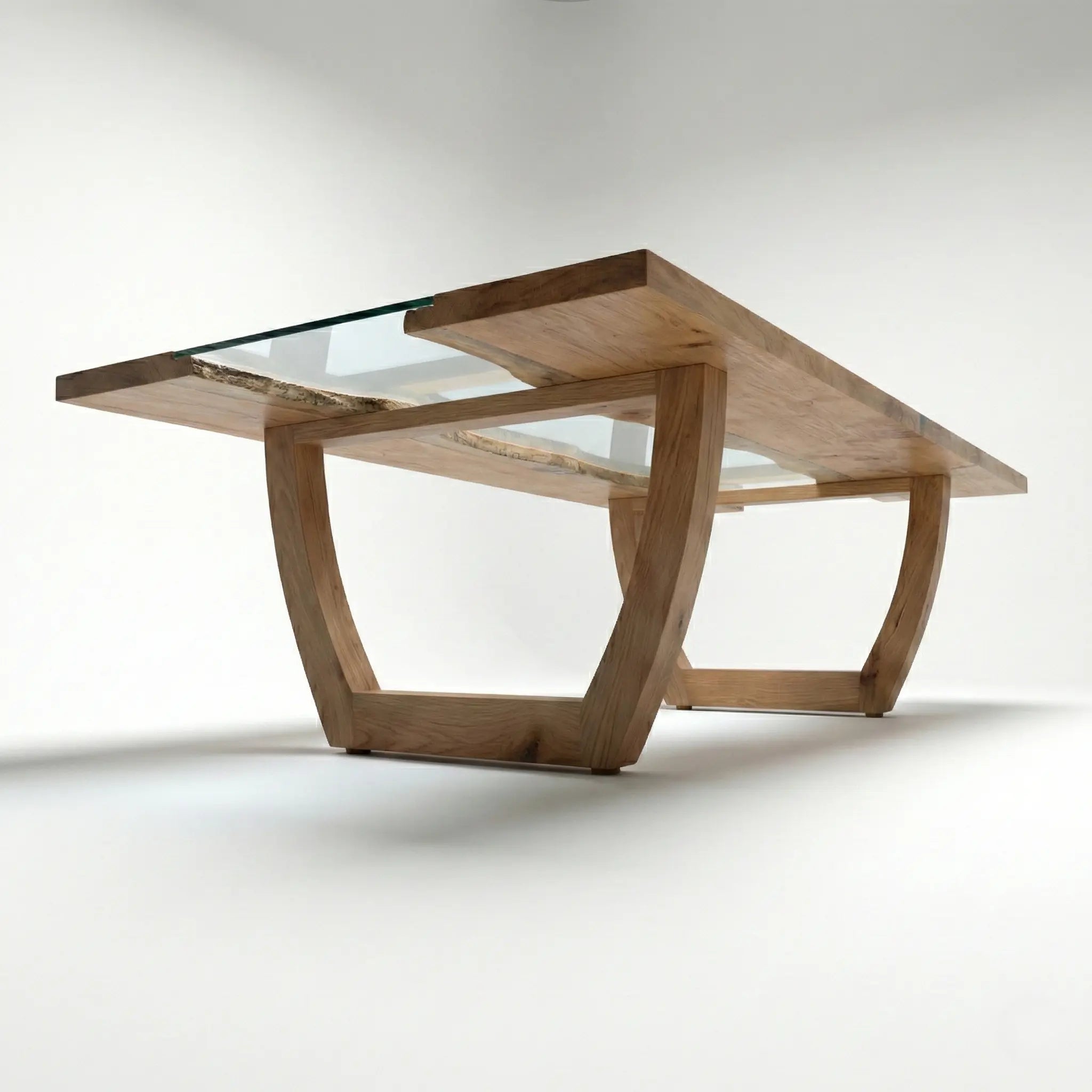 Underside view of Nolan solid wood dining table showing sculpted wooden base and glass insert support.