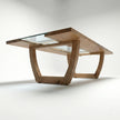 Underside view of Nolan solid wood dining table showing sculpted wooden base and glass insert support.