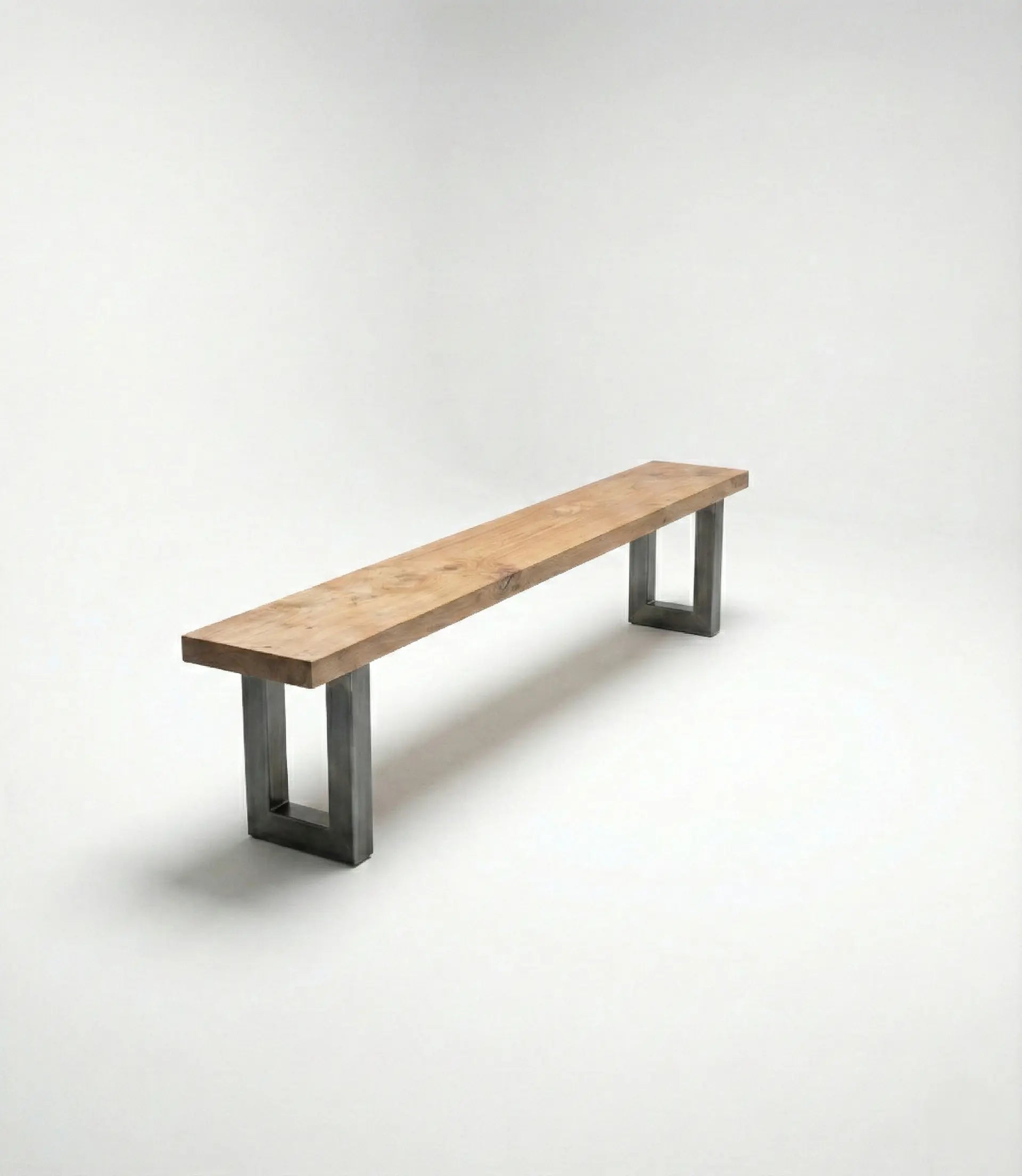 Angled view of Nolan wood and metal dining bench designed to pair with glass top dining table.