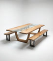 Studio view of Nolan wood and glass dining table with benches featuring metal frame legs.