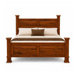 A classic wooden bed frame with a rich reddish-brown finish, styled with cream bedding and two brown pillows against a solid white background.