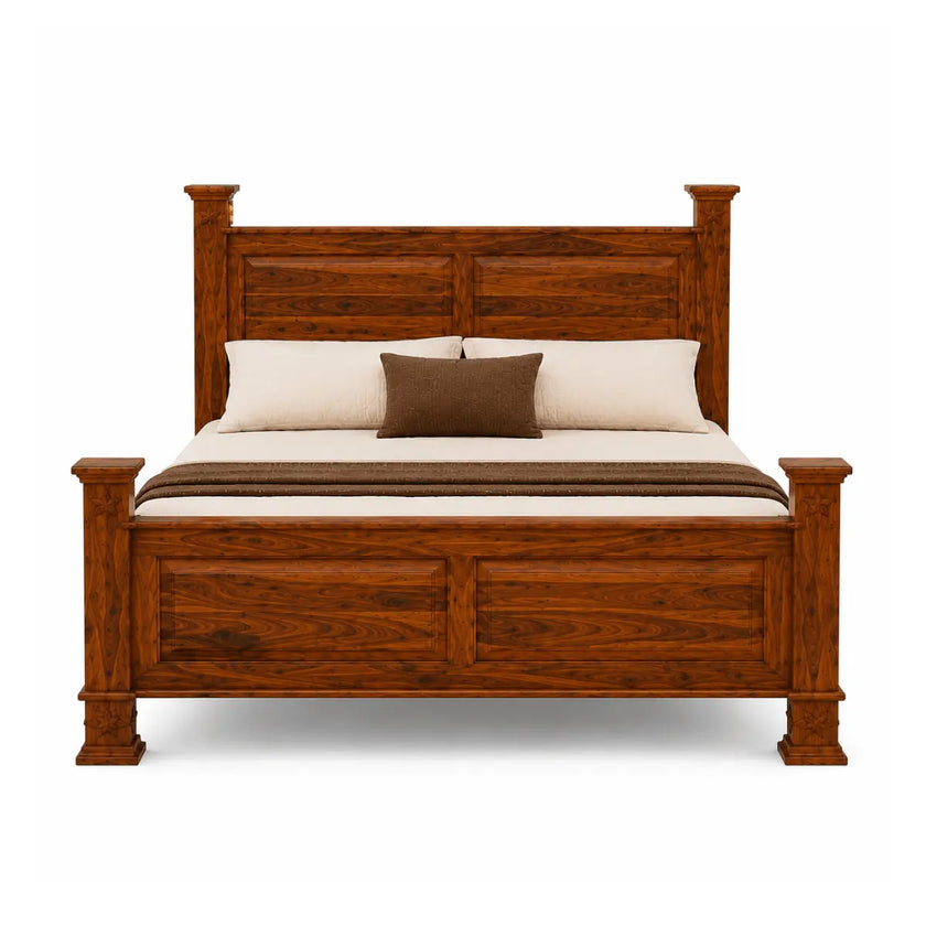 A classic wooden bed frame with a rich reddish-brown finish, styled with cream bedding and two brown pillows against a solid white background.