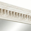 Close-up of the distressed vintage white finish on the wall mirror frame