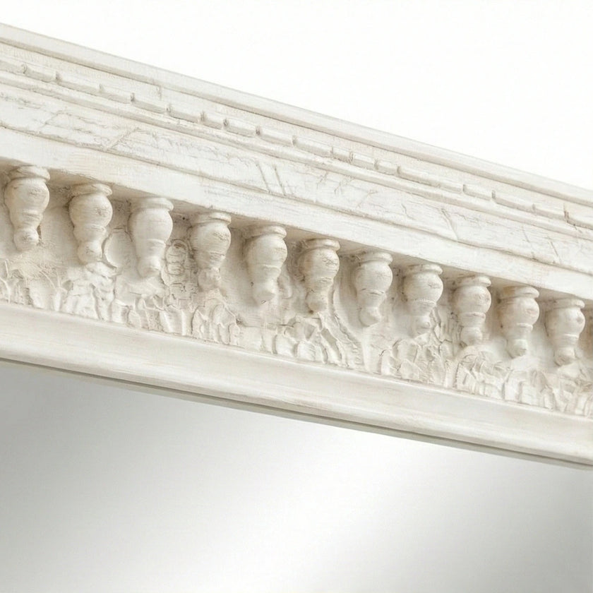Close-up of the distressed vintage white finish on the wall mirror frame